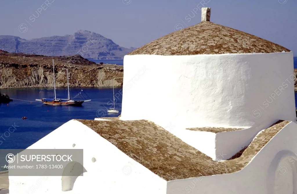 Small whitewashed chapel by coast in Lindos, Rhodes, Greece 