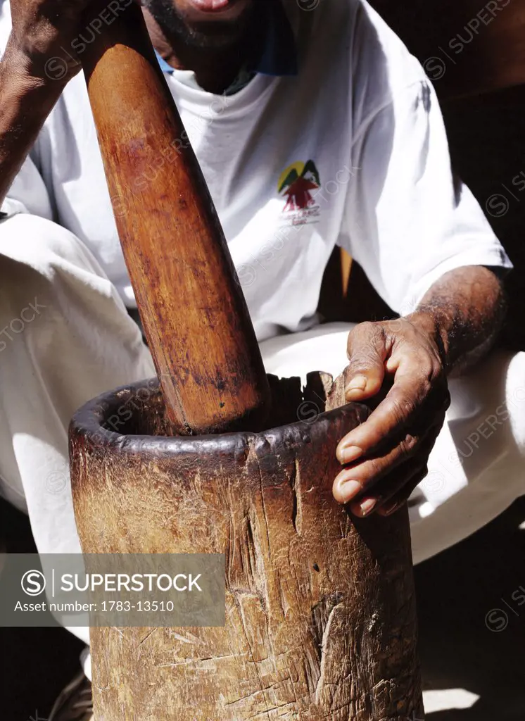 Man crushing with mortar and pestle, Grenada