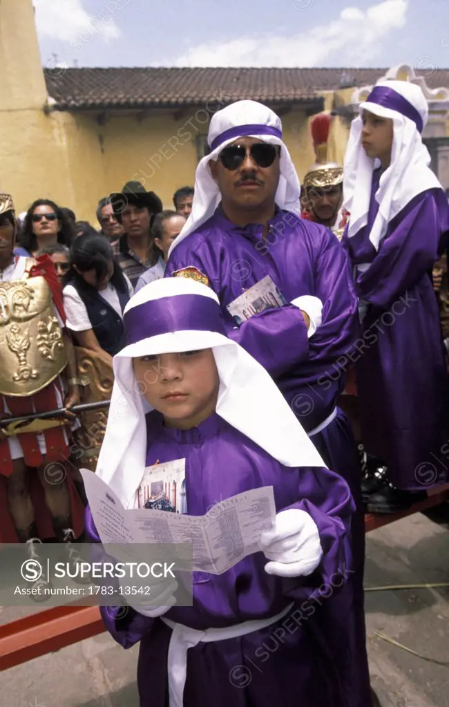 Man and boy dressed in purple robes, Semana Santa, Huehuetenango  , Antigua, Guatemala.