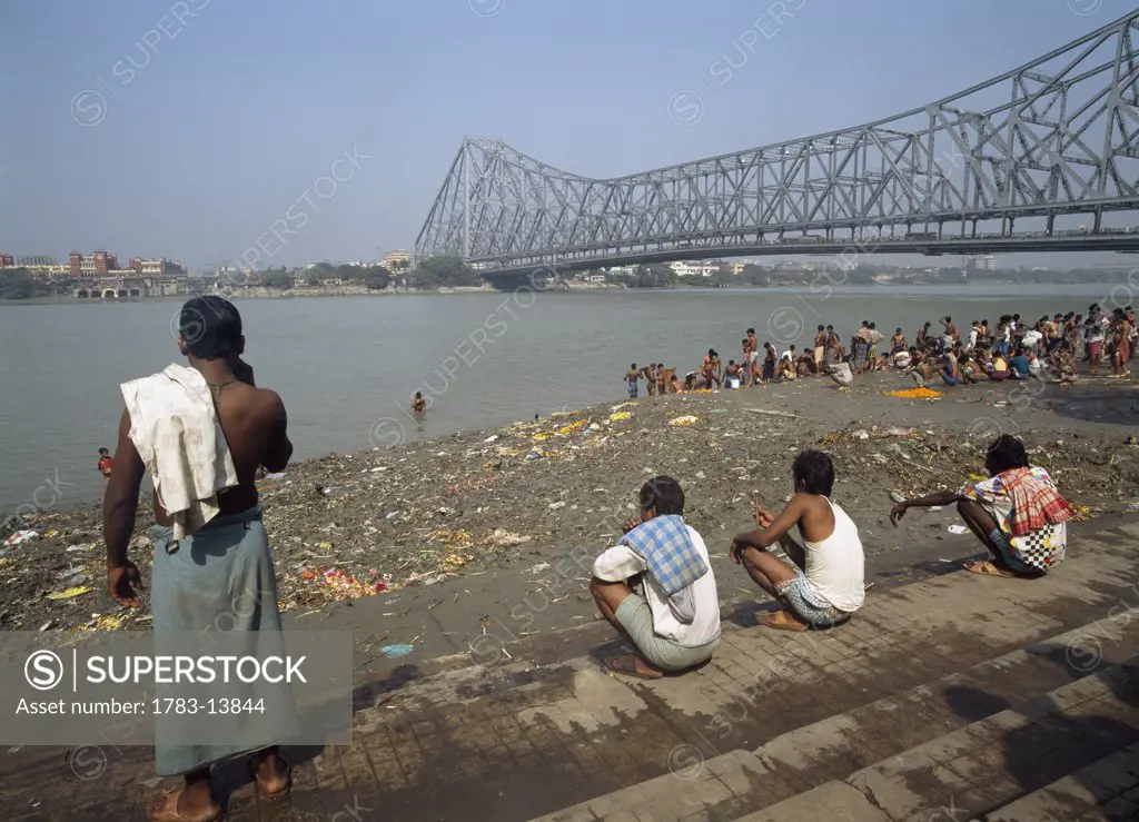 Pilgrims beneath Howrah Bridge, Calcutta, India.