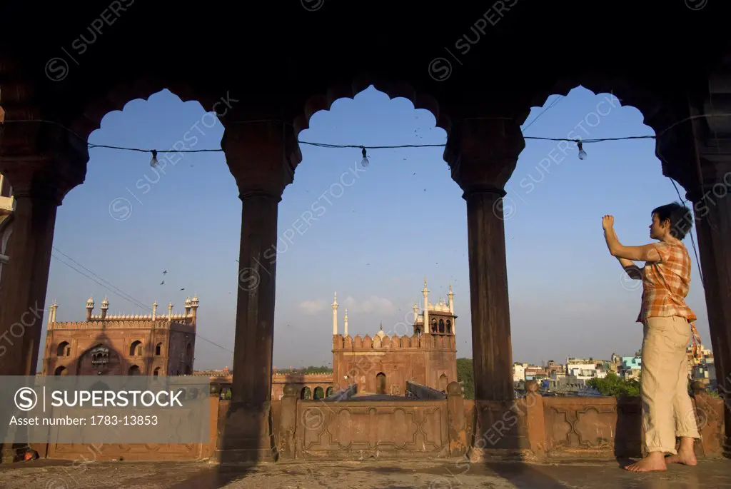 Tourist photographing the Jami Masjid, New Delhi, India