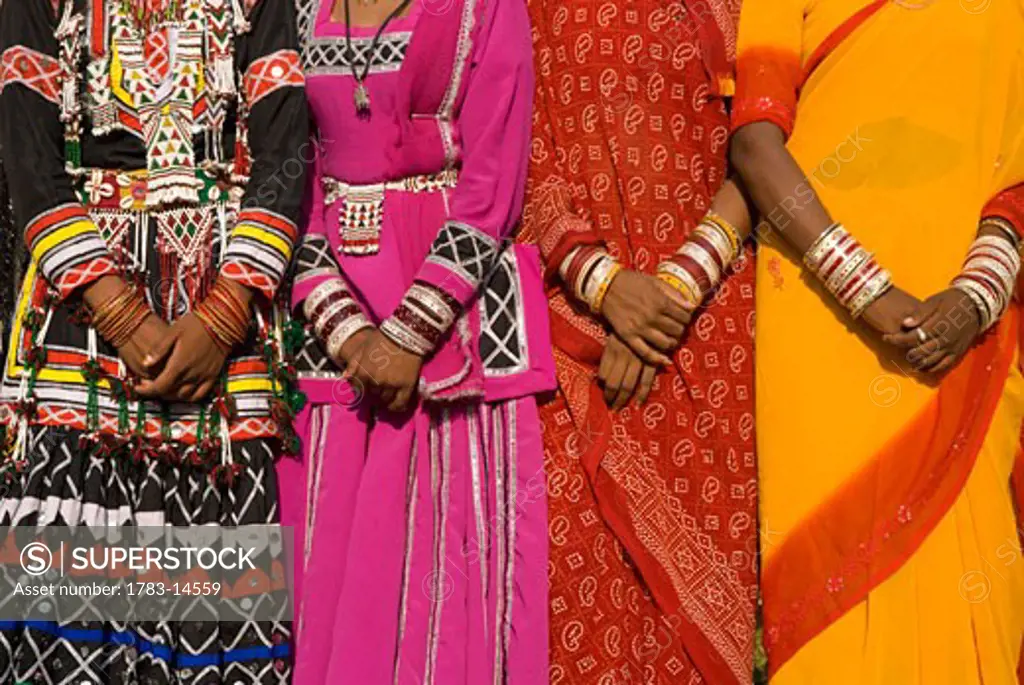 Detail of hands four women in saris, Jaipur, Rajasthan, India