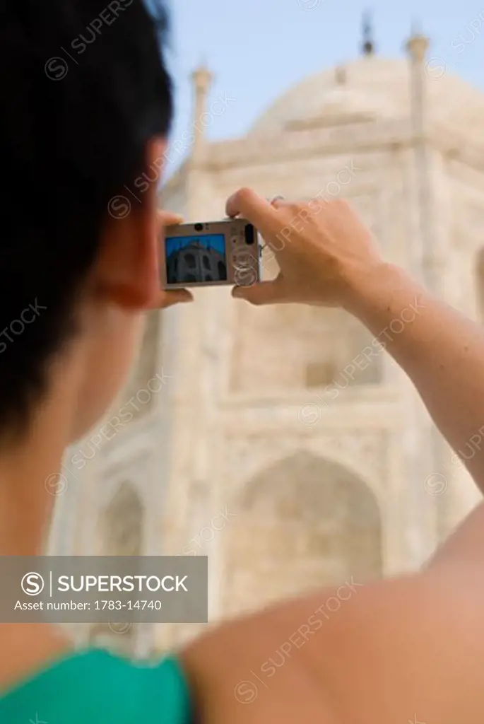 Woman photographing  the Taj Mahal at dawn, Close Up,  Agra, Uttar Pradesh, India