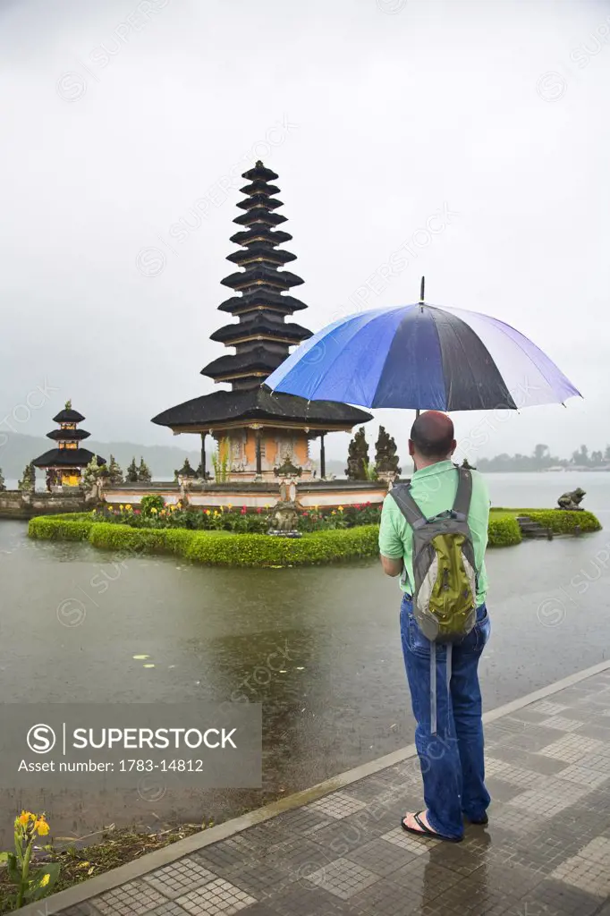 Tourist looking at temple Pura Danu Beratan, Bali, Indonesia.
