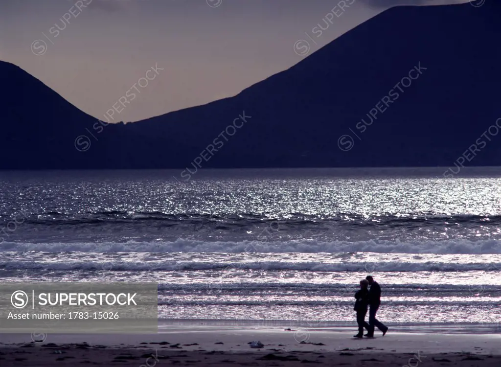 People walking along beach in silhouette, Inch, Dingle peninsula, Kerry, Ireland