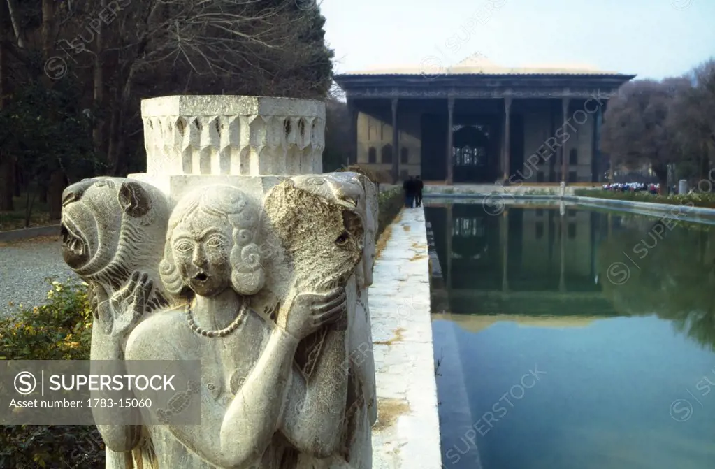 Stone statue and pool, Chehel Sotun Palace, In the Palace Shah Abbas II and his successors would receive dignitaries and ambassadors, Esfahan, Iran.