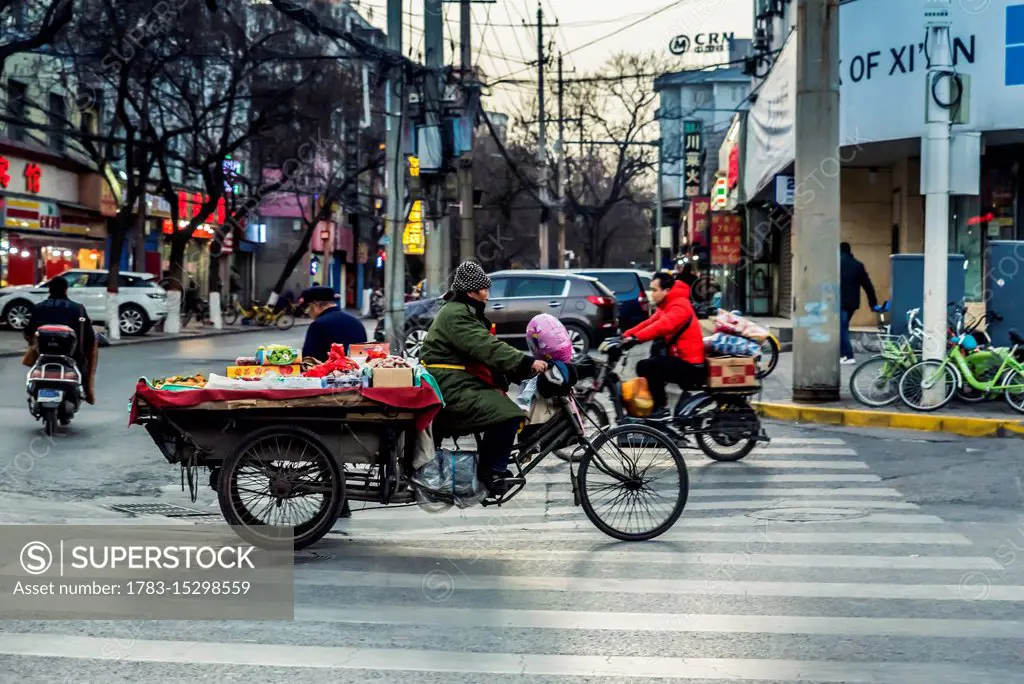 Vehicle carrying fruits and vegetables in the streets of Xian; Xian, Shaanxi Province, China