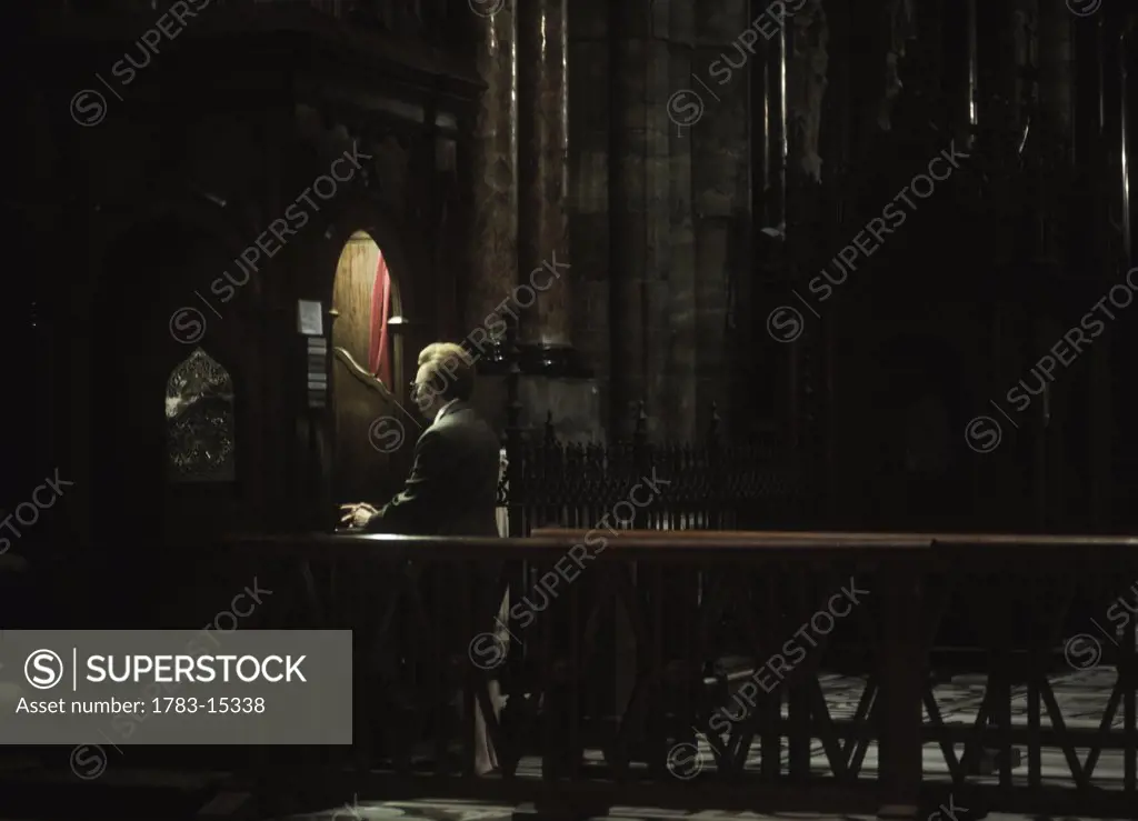 Old lady making confession to priest in the Duomo,  , Milan, Italy.