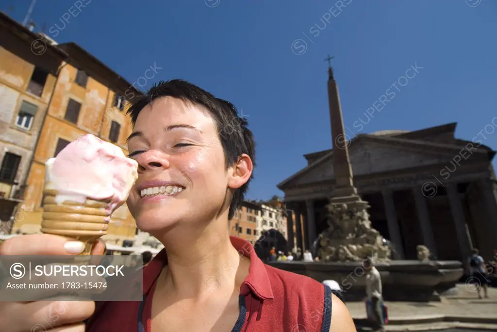 Woman eating ice cream in front of the Pantheon, Rome, Italy