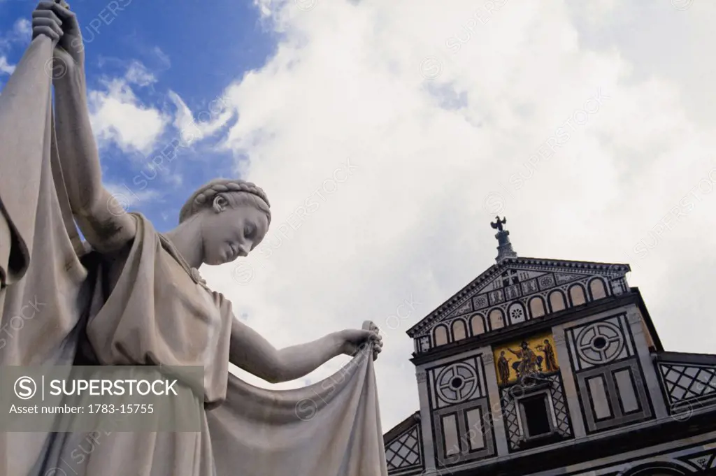 Basilica di San Miniato al Monte and statue, low angle view, Florence, Tuscany, Italy