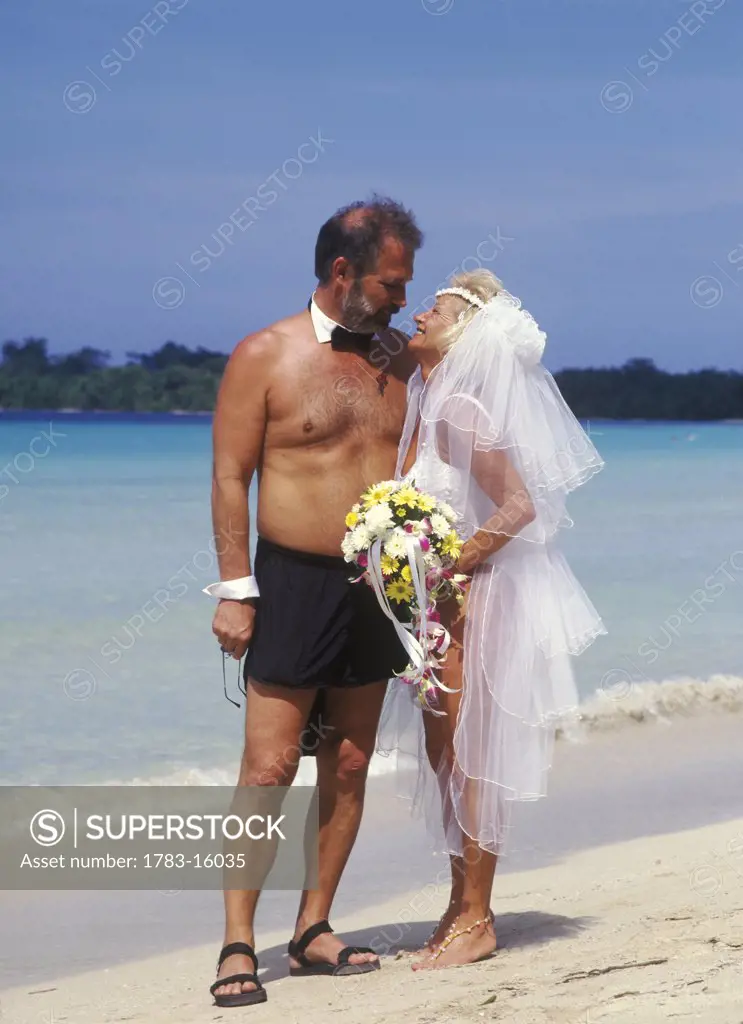 Couple getting married on beach, Jamaica.