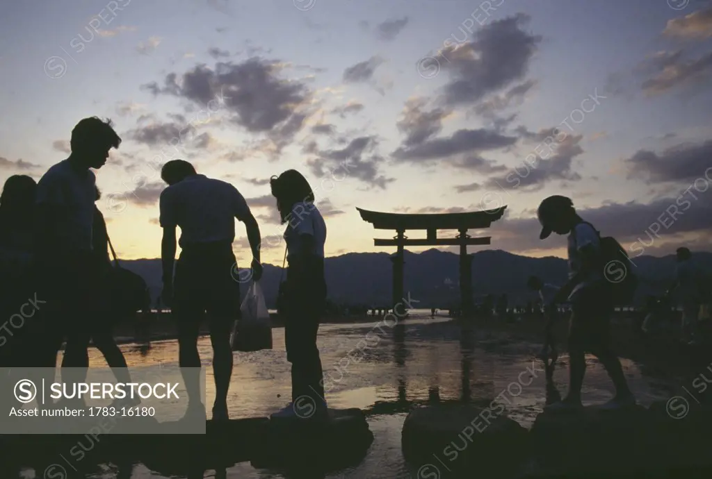 Family at Itsukushima Shrine at dusk, Miya Jima, Japan