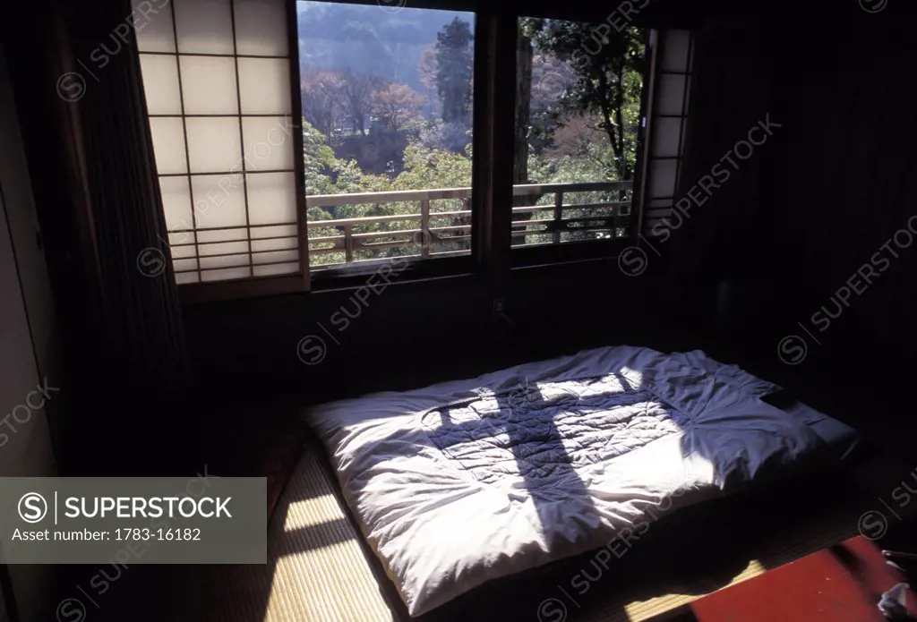 Light shining on futon in traditional Japanese interior, Yoshino, Nara, Japan