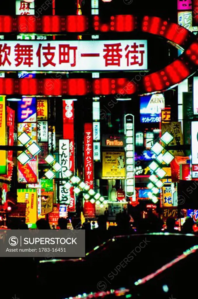 Neon signs over busy street at night, Japan, Tokyo