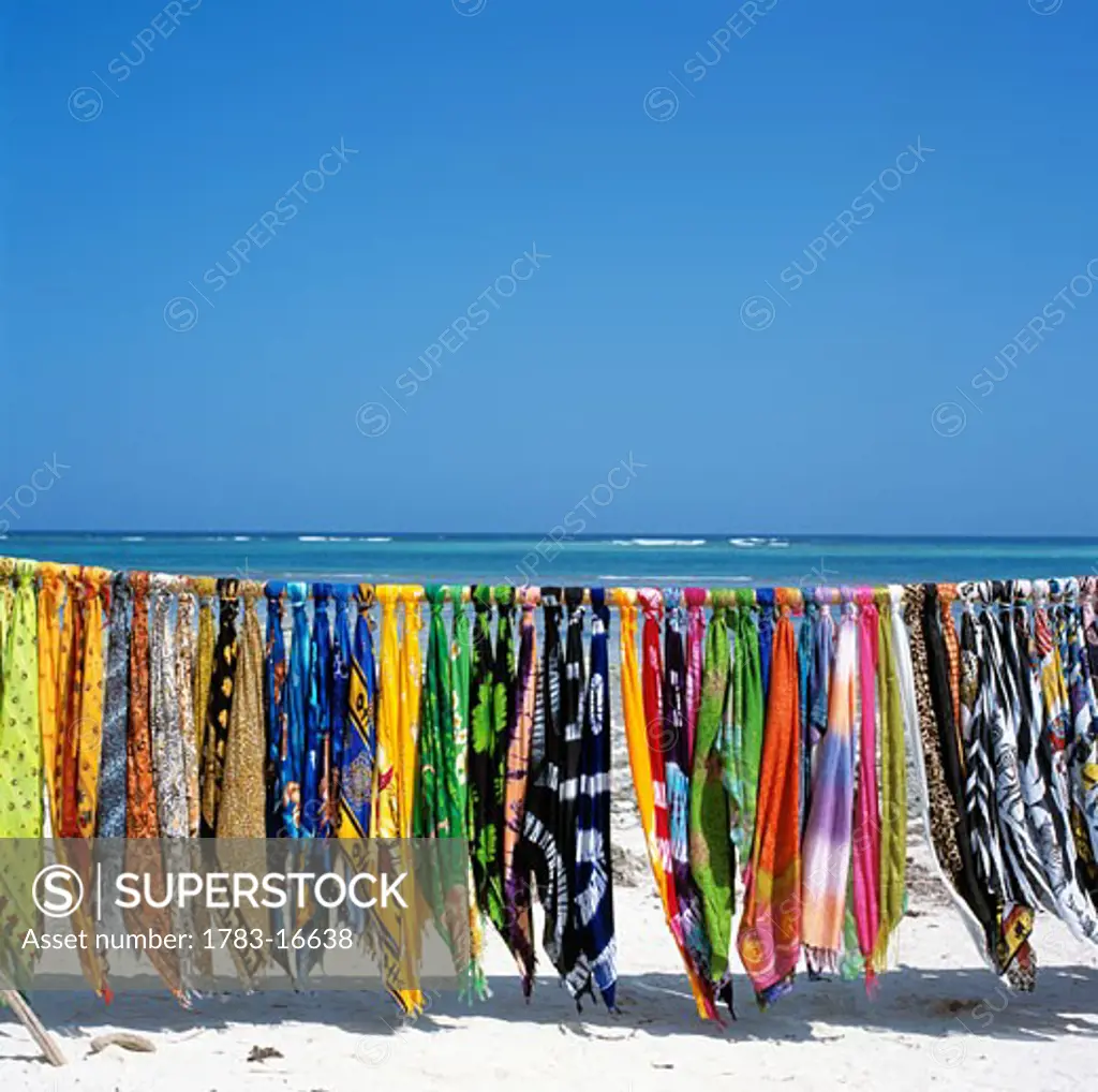 Colorful sarongs hanging over white sand beach, Diani Beach, Mombasa Coast, Indian Ocean, Kenya