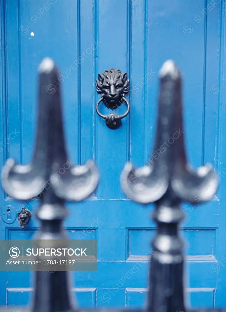 Blue door with lion door knocker as seen through iron fence, London, Westminster, London 