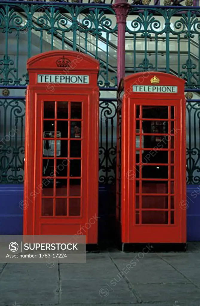 Red telephone booths, Smithfield Market, London, England, UK.