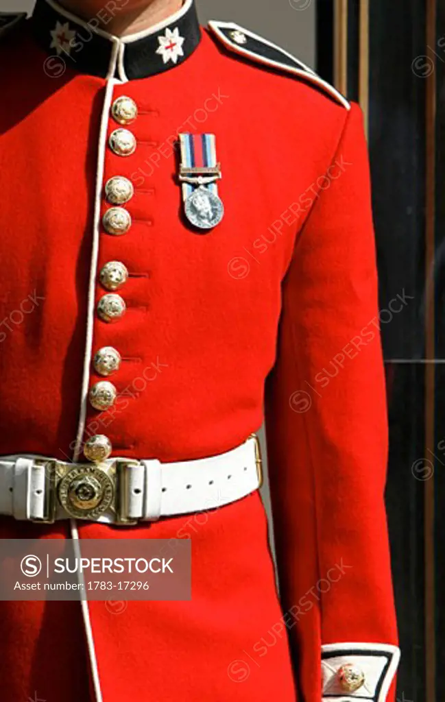 Soldier of Queens Household Division guarding Buckingham Palace, mid section, London, England.