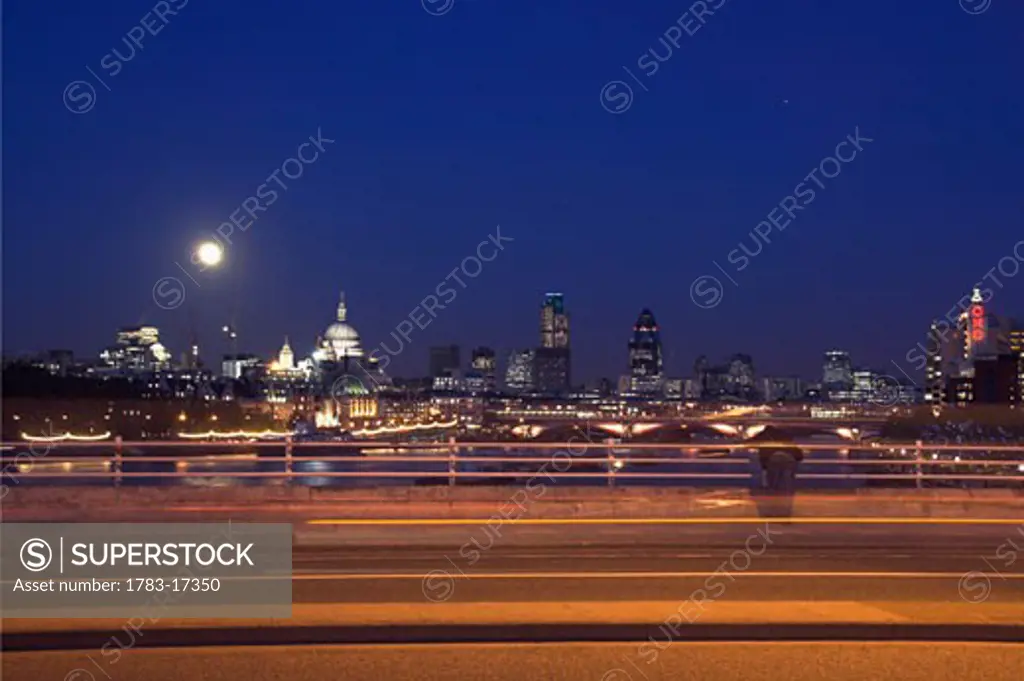 Skyline at dusk with moon with Waterloo Bridge , London, England.