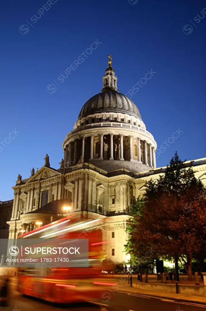 Red double decker bus passing St Paul's Cathedral, Blurred Motion, London, England