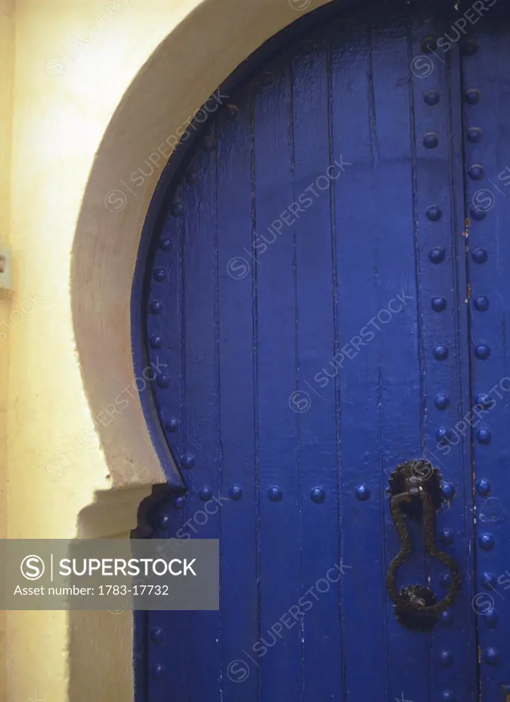 Curved blue and white doorway with knocker, Close up, Essaouira, Morocco