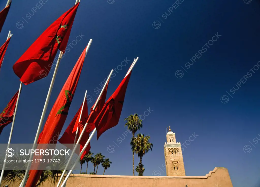 Maroccan flags in front of Koutoubia mosque, Marrakesh, Morocco