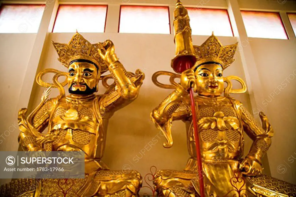 Gold buddhist statues inside Sam Poh Temple, Pahang, Malaysia.