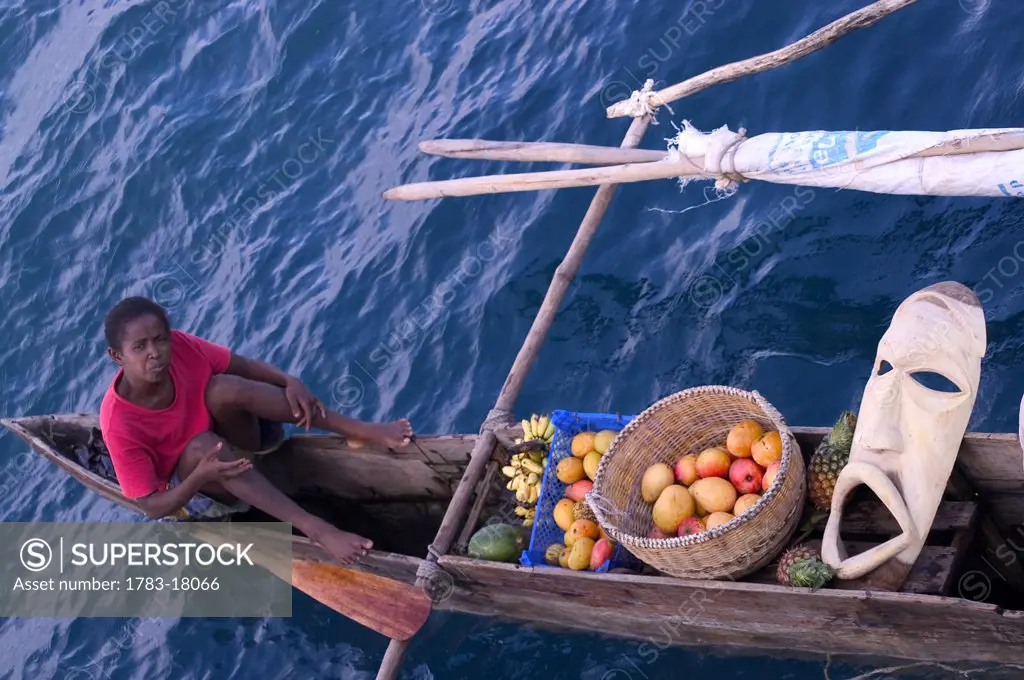 Woman selling fruit from a boat, Nosy Be, Madagascar.