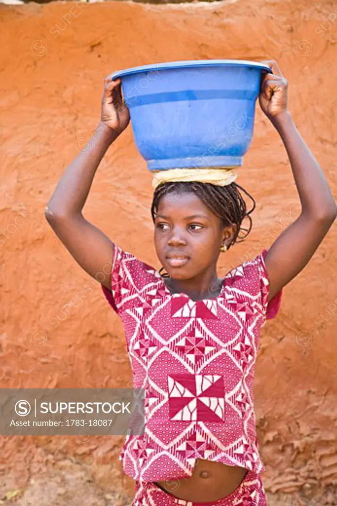 Girl carrying bowl on head, Segoukoro, Segou, Mali.