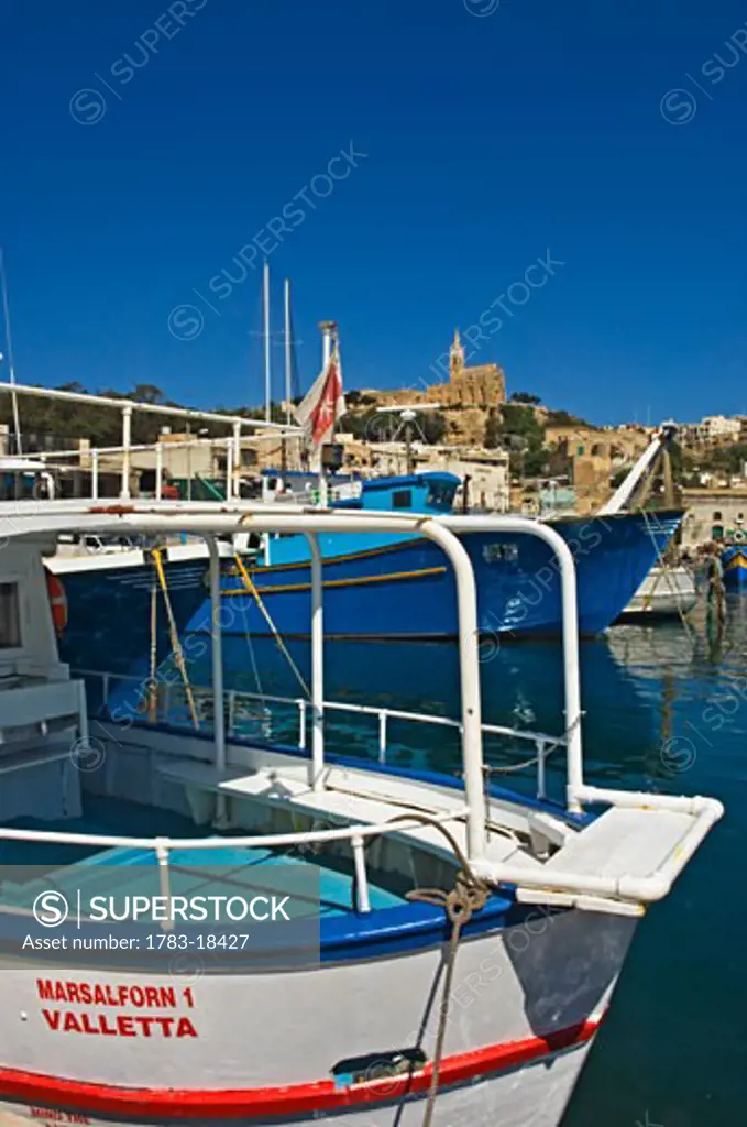 Moored fishing boats at Mgarr Harbor, Gozo Island, Malta.
