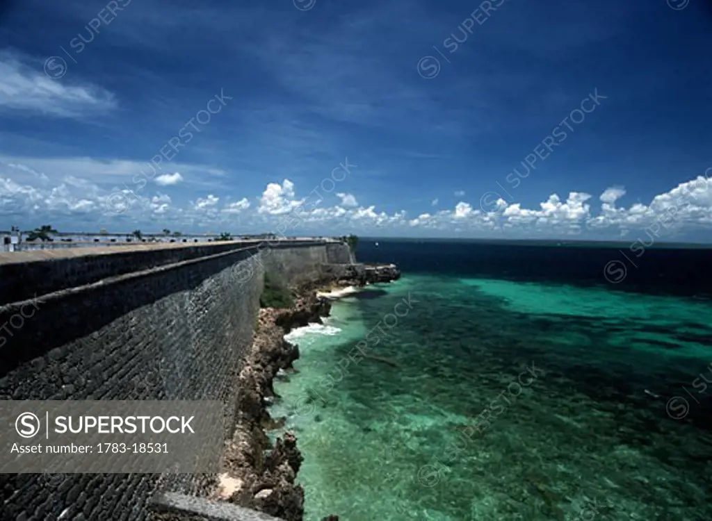 Dhow sailing past walls of Fort of Sao Sebastiao, Ilha de Mocambique, Mozambique.