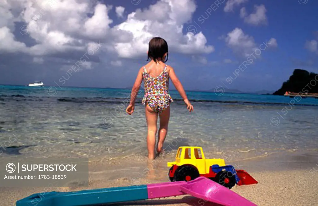 Girl (4-5) walking on beach, Mustique, St Vincent and the Grenadines.