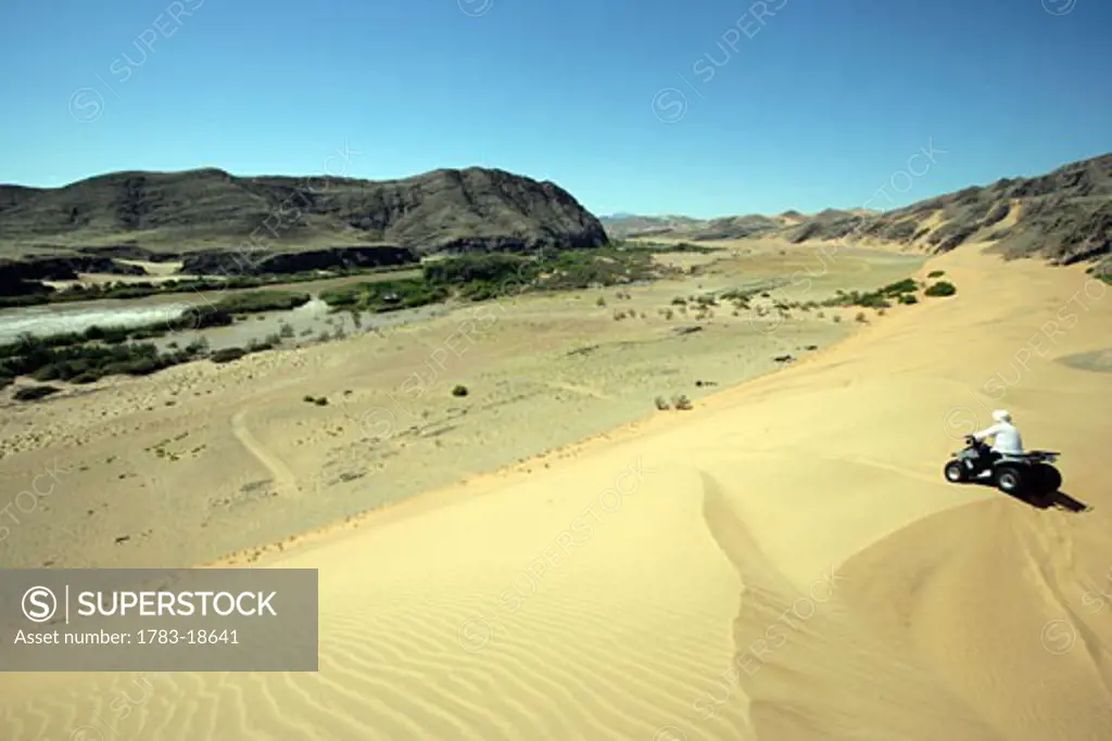 Woman quad biking in Koakoland Desert, Koakoland Desert, North West Namibia