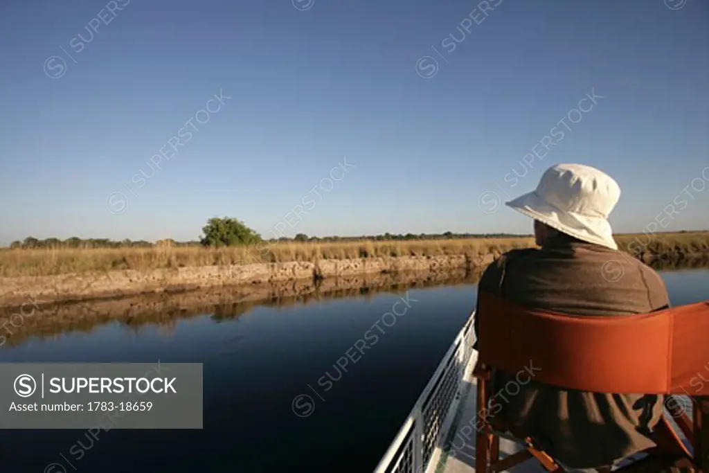 Tourist taking a boat trip on Kwando River, Caprivi Strip, Namibia