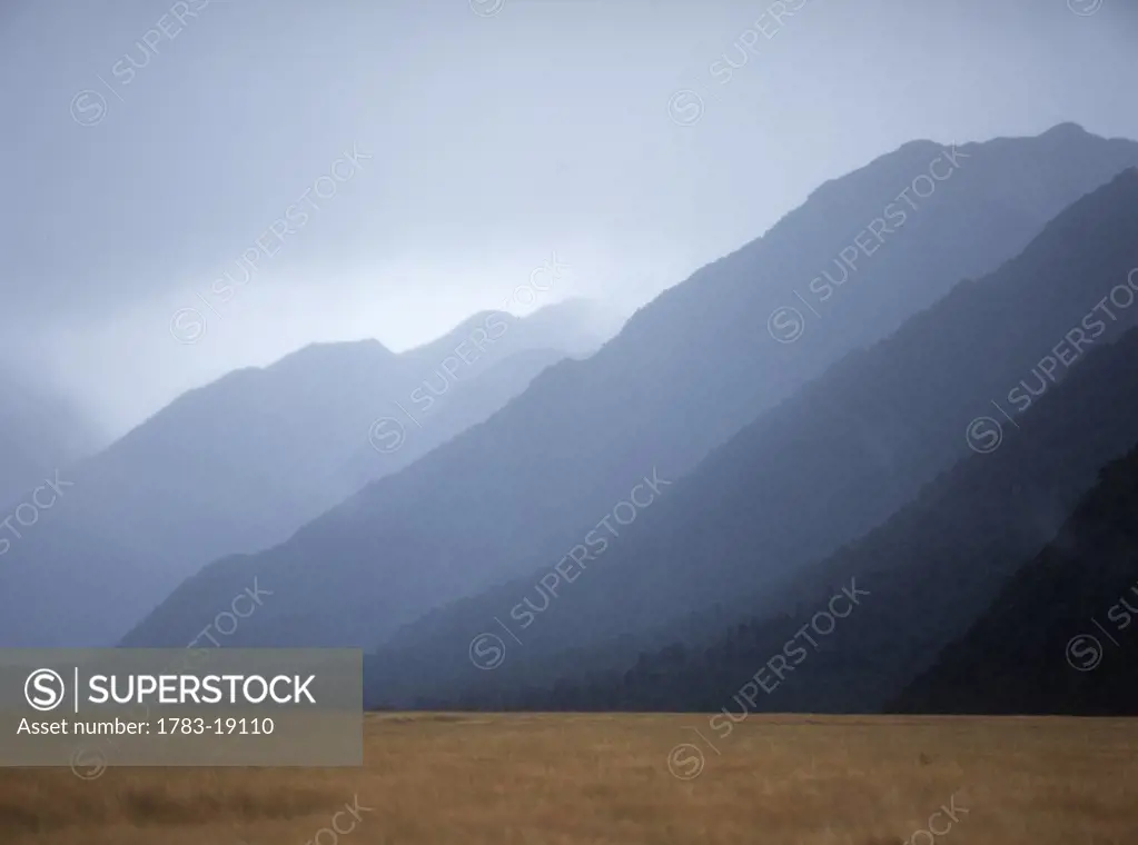 Looking down flat bottomed valley to misty hills, Fiordland National Park, South Island, New Zealand.