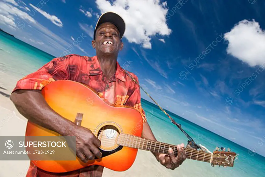 Calypsonian playing his guitar on Grand Anse Beach, Grenada.
