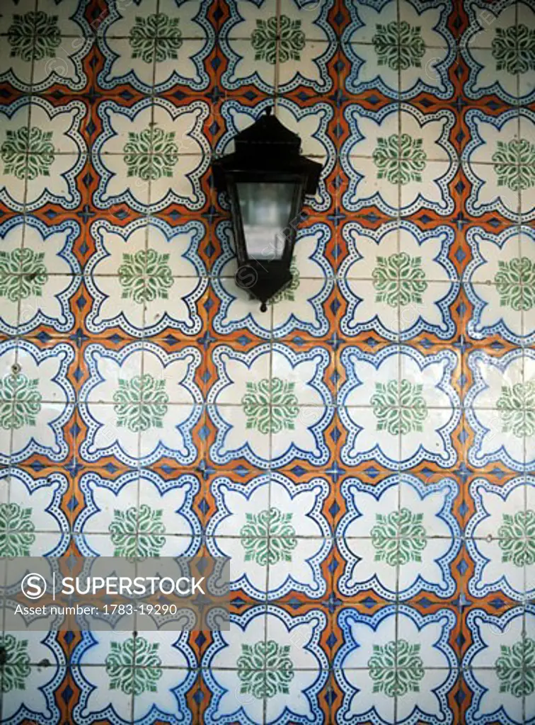 Lantern in front of wall covered with floral pattern, Sintra, Lisbon, Portugal.
