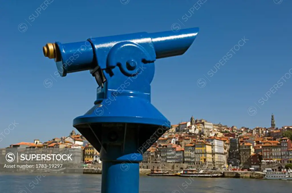A blue tourist telescope beside the quayside at Oporto, Portugal