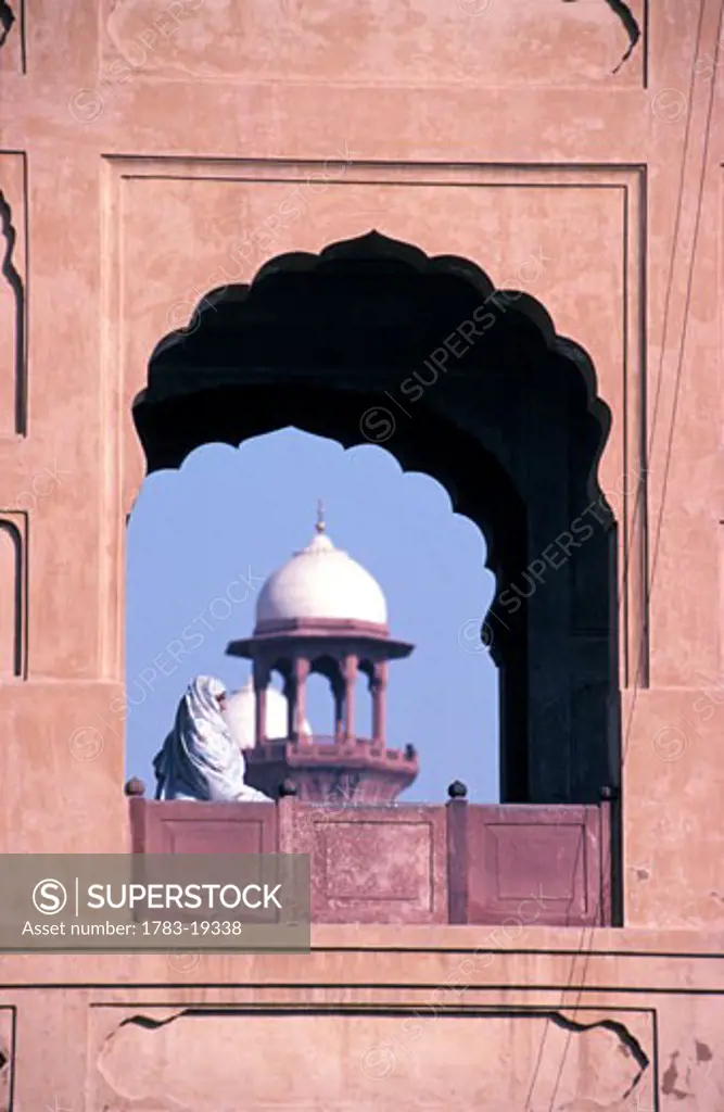 Woman at Badshahi Mosque window, Lahore, Pakistan.