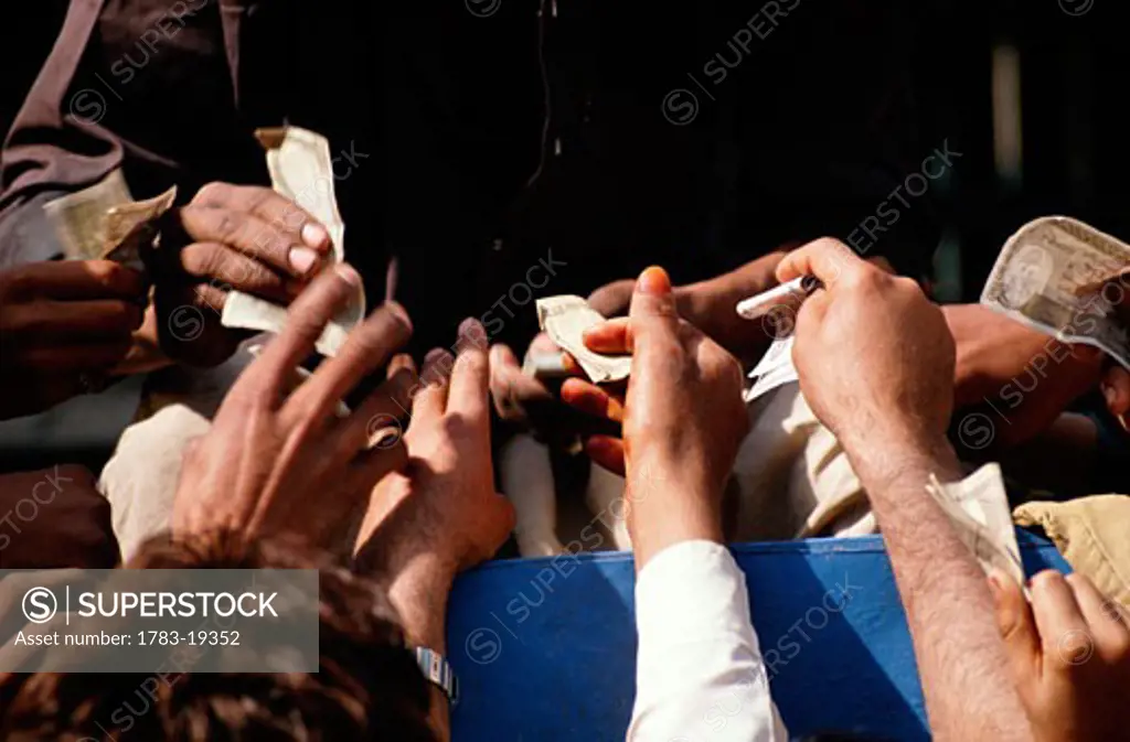 People taking money at a fair, Pakistan