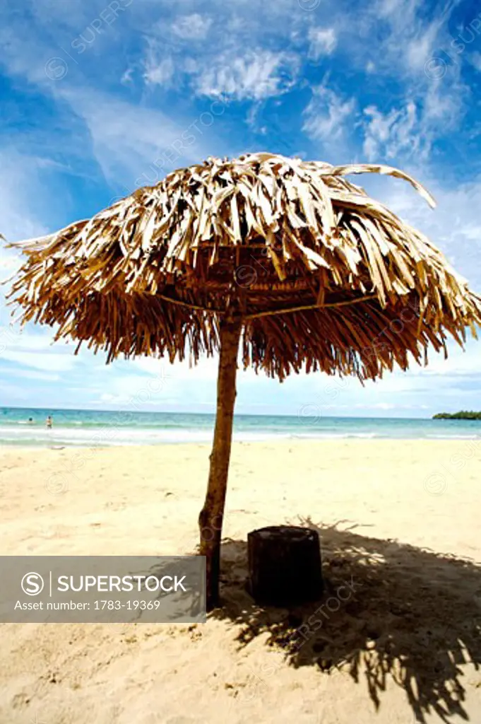 palm leaf umbrella on Red frog Beach, Bastimentos National Park, Bocas del Toro, Panama.