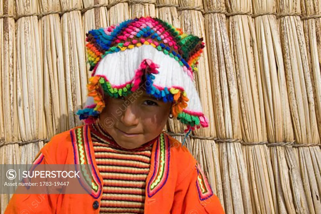Portrait of little girl in traditional clothing, Uros Islands, Lake Titicaca, Peru.