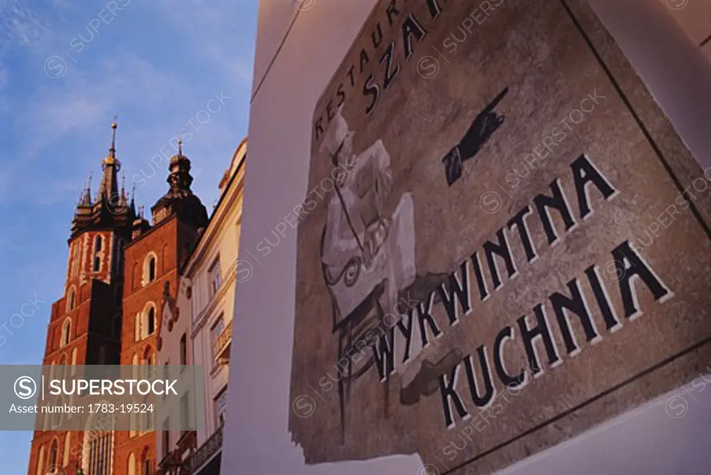 Saint Marys Church and old sign in Main Market Square , Krakow, Poland  