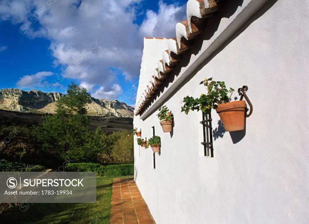 View along the white wall of a finca. , Andalucia, Spain.