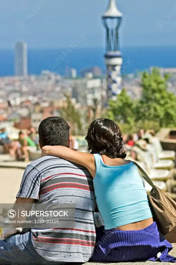 A young couple admires the view at Park Guell, Barcelona, Spain 