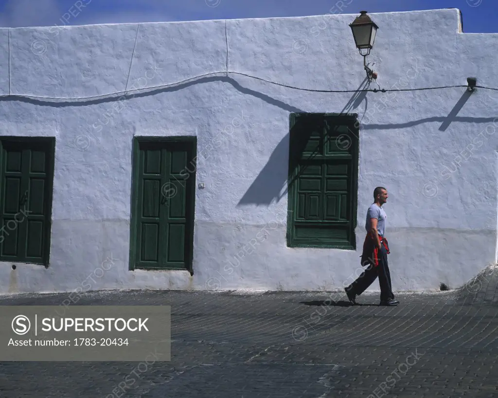 Man walking down the street, Teguise, Lanzarote, Canary Islands, Spain.