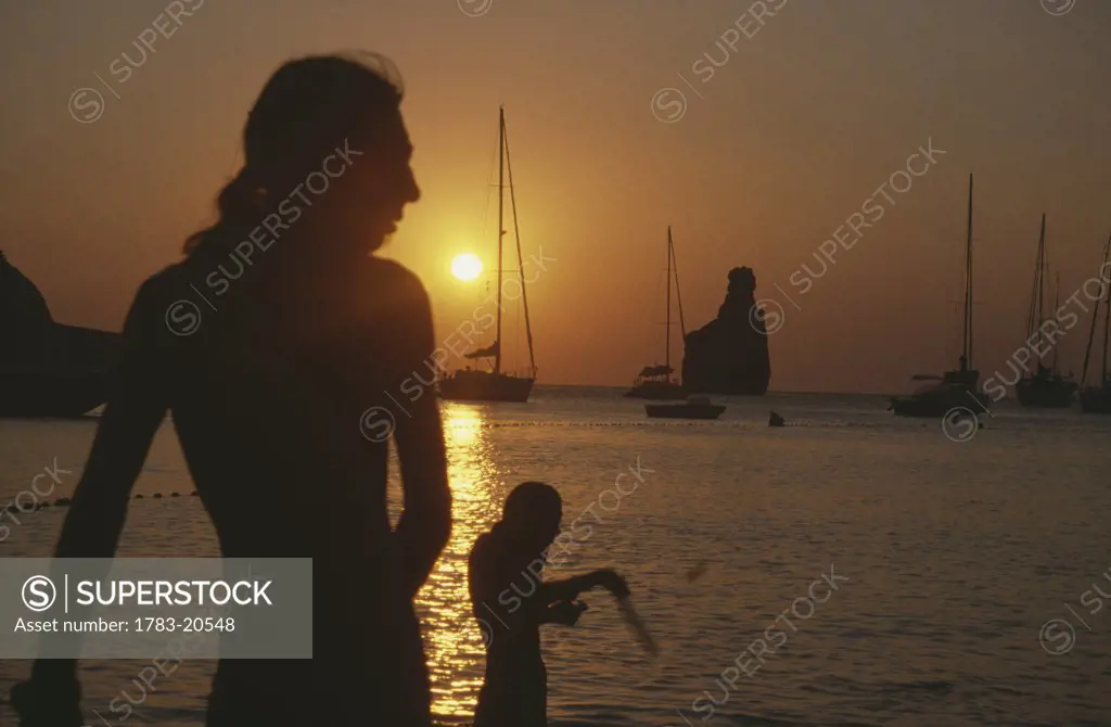 People in silhouette at Benirras Beach, Ibiza, The Balearic Islands, The Balearics, Spain
