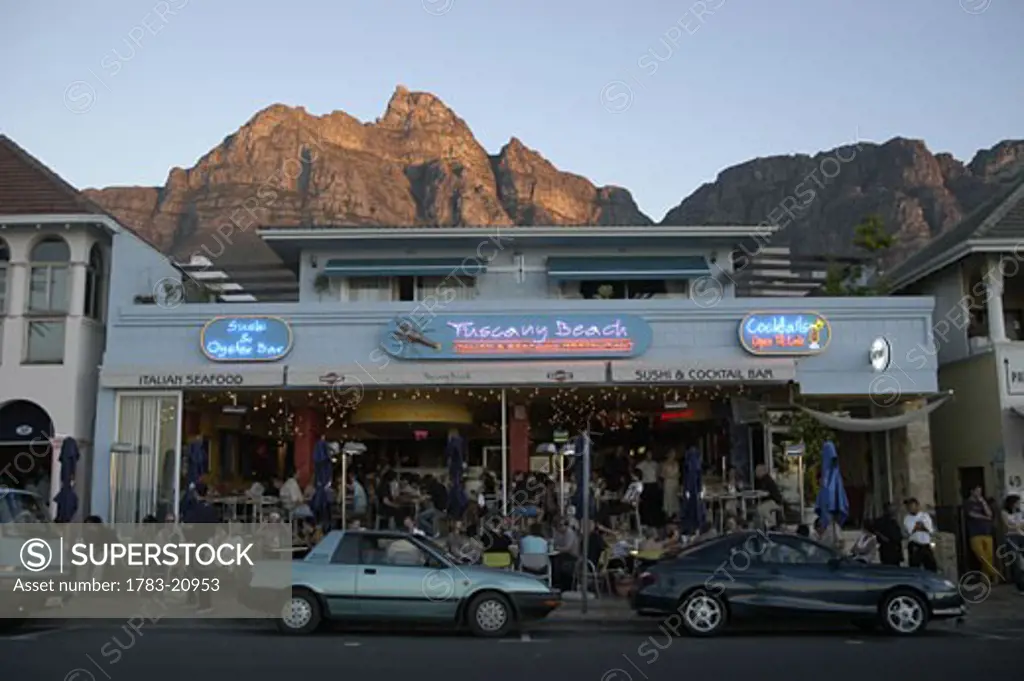 People in bar in Clifton with Table Mountain above, Cape Town, South Africa.