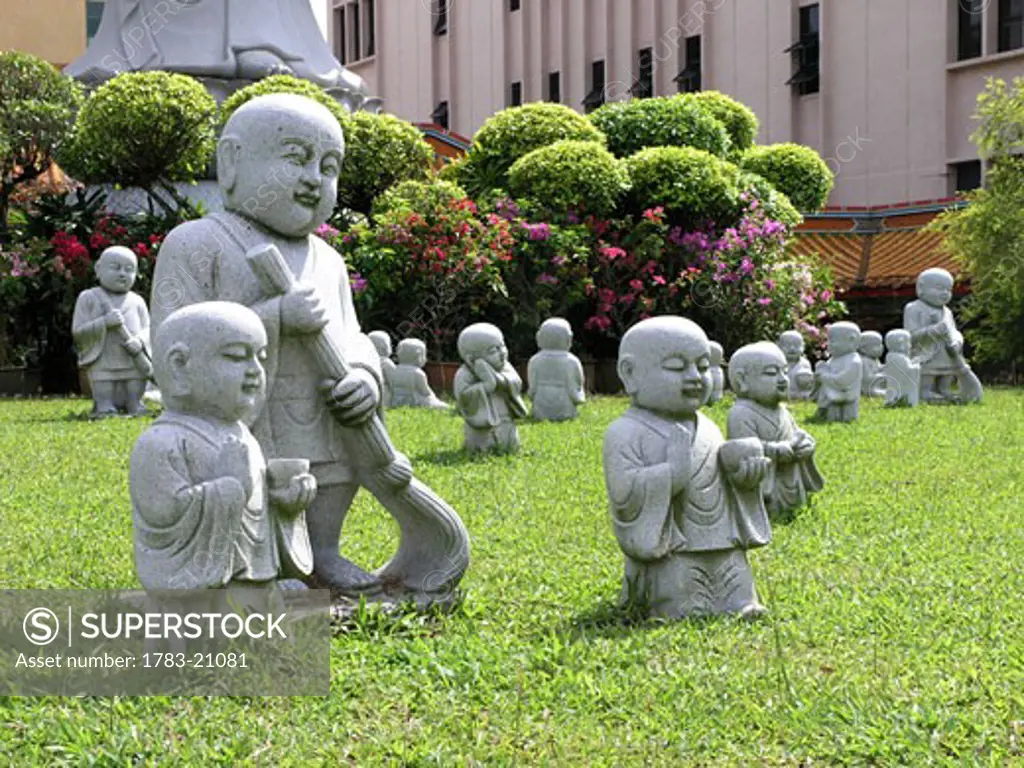 Buddhist statues on lawn, Kong Meng San Phor Kark See Monastery, Singapore.