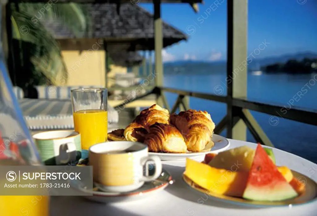 Breakfast of fruit and croissants by the sea , Vanuatu